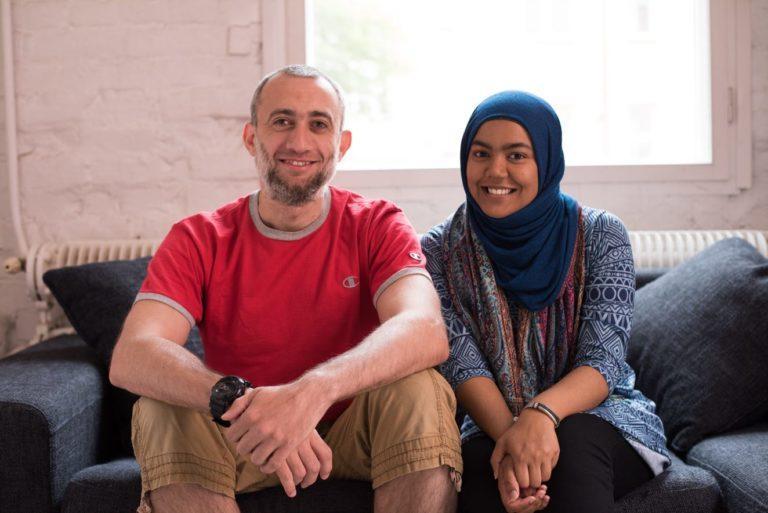 Information about HIV can help HIV positive person live a fulfilling life. In the photo two people are sitting on the couch smiling.